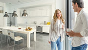 Frau und Mann stehen in Ihrer modernen Küche mit Fußbodenheizung